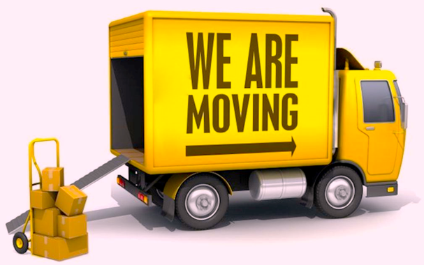Image of a yellow moving truck with a stack ob boxes to be loaded.