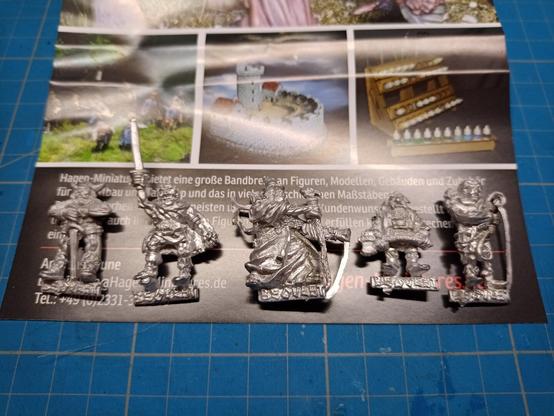 Close-up 5 metal unpainted metal miniatures with a resemblance to TLotR fellowship