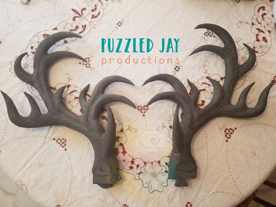 two grey EVA foam antlers on a table