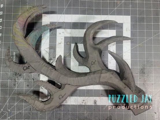 two grey EVA foam antlers on a table