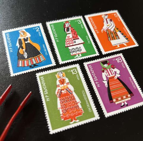 A collection of five colorful Bulgarian postage stamps featuring traditional costumes.