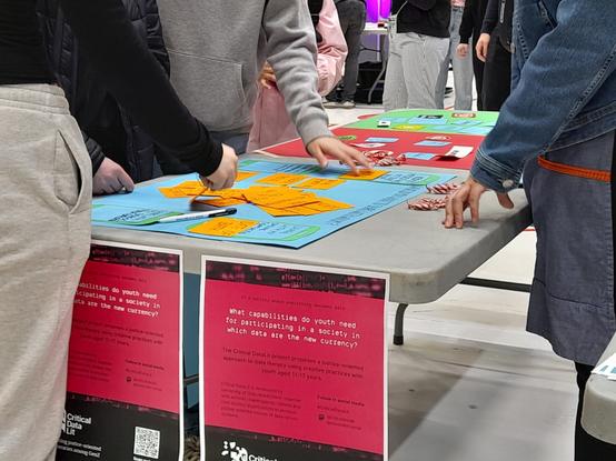 Visitors playing with the Critical Data Lit prototypes at Amazing North event