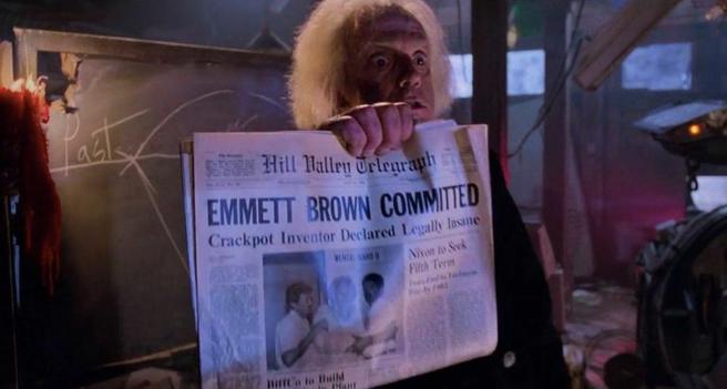 A man holds up a newspaper with the headline, "Emmett Brown Committed. Crackpot inventor declared legally insane"
