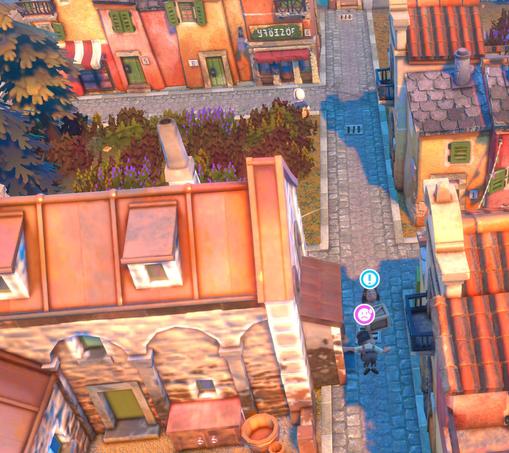 Game screenshot, an aerial view with two small cartoony characters in a narrow cobbled street between buildings. One is carrying a wooden box and has a ! icon over their head, the other has fallen on their face and has an anxious frowning-face icon over their head.