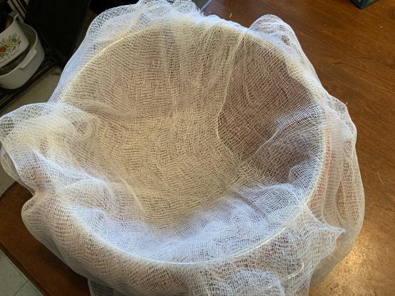 Cheese making.  Strainer lined with cheesecloth
