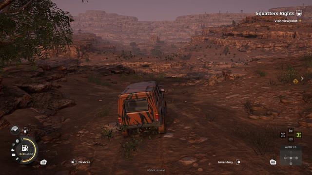 A screenshot of the video game 'Expeditions: A MudRunner Game' showing a small scout vehicle at the top of an orange ridge in the desert.