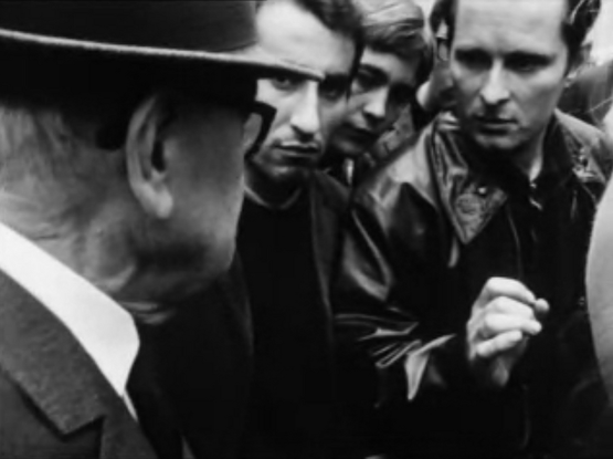 Sorbonne students discussing the political situation with an older man.