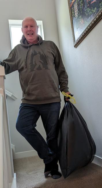 Older bald guy, big smile, green Sasquatch hoody & carrying a trash bag full of clothes for vaca. Standing on https://images.homedepot-static.com/productImages/2771b888-9741-46a3-ba45-337d739b0ff5/svn/earth-worth-tool-accessories-hwd630032-64_1000.jpg.