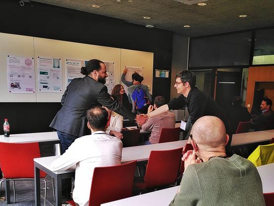 Two people shaking hands during a workshop