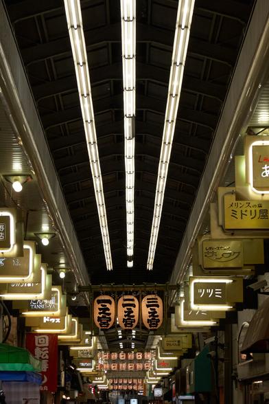 The faded signage glowing during the evening in a covered street/shopping mall (Shotengai) next to the Asakusa Shrine in Tokyo.