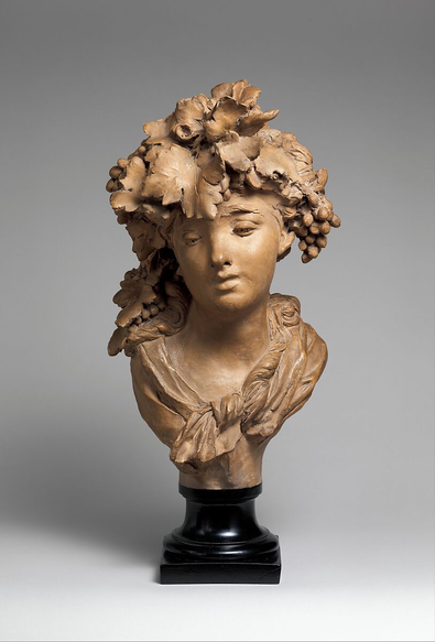 Bust titled "Bacchante" by Auguste Rodin. The bust s a young woman's face with a crown of grapes and grape leaves.