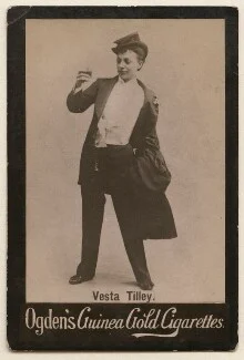 Image of Vesta Tilley in suit and hat, standing with the caption "Vesta Tilley" above "Odgen's Guinea Gold Cigarettes"