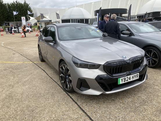 Silver BMW i5 Touring, front quarter view