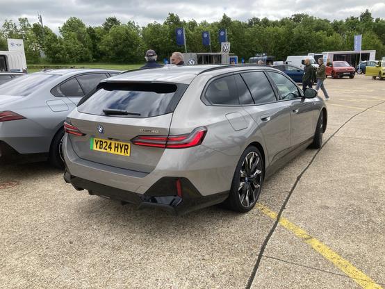 Silver BMW i5 Touring, rear quarter view