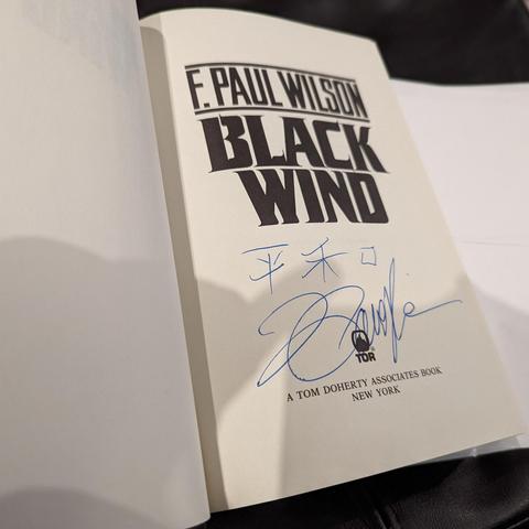 Title page of "Black Wind" with F. Paul Wilson's autograph.