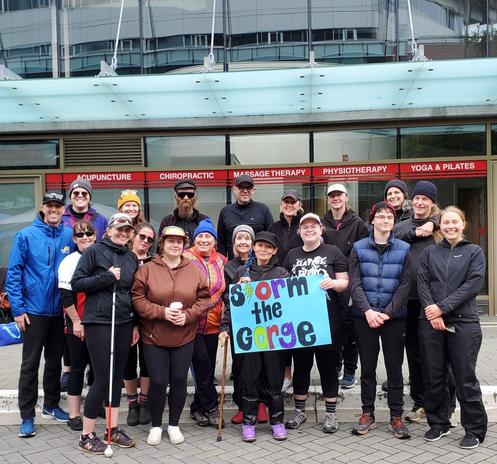Our team, Storm the Gorge! Team photo - I'm holding up a blue poster sign with our team name in colourful text.