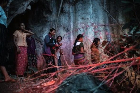 Karenni women and children move into a cave to escape military air strikes