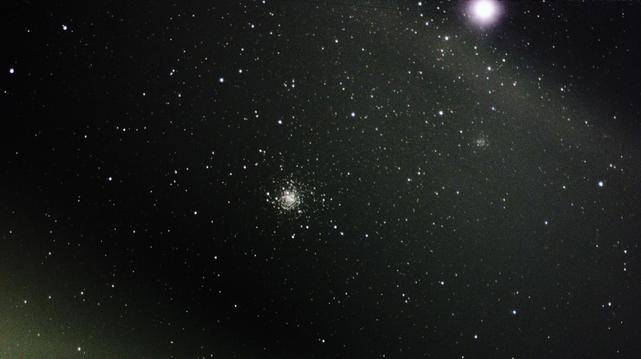 Messier object 4, with light from the moon and stars and other celestial objects around.
