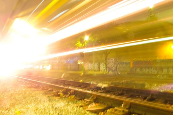 Streams of light as a train goes by at night.