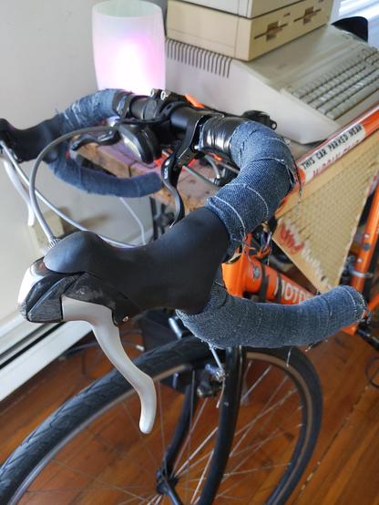 Bicycle handlebars wrapped in the discarded leg bottoms of a freshly created pair of jorts