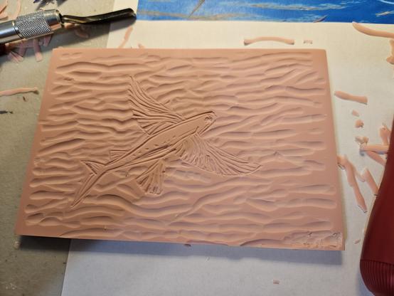 Lino cut block next to model photo