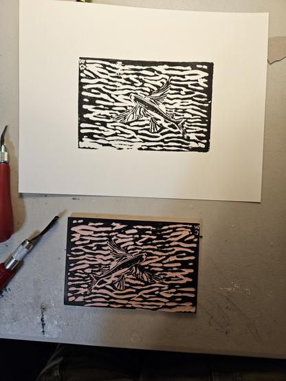 Inked linocut block with first print of a flying fish