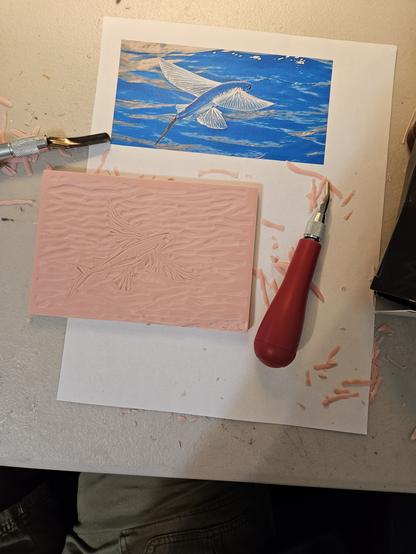 Linocut block of a flying fish