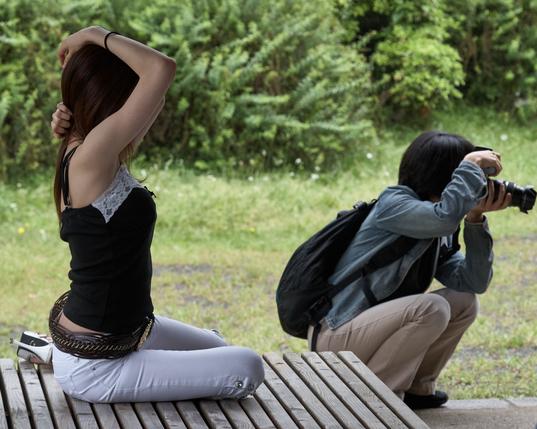 A model strikes a pose in Hama-rikyū Gardens in Tokyo, while the nearby photographer focuses on a more important subject…