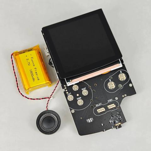 picture of FPGBC game boy clone bare pcb with battery and speaker beside it