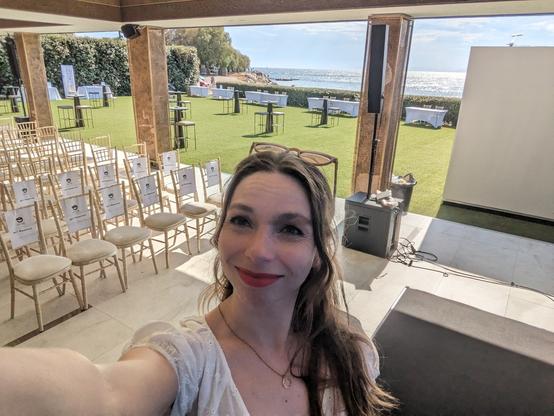 Me on stage for the MOT Athens meetup in a room that opens to a terrace right on the beach of the glittering Mediterranean