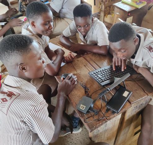 photo - schoolchildren around laptop, Africa