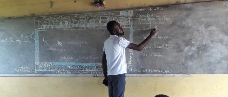 photo - teacher at blackboard, computer class, Africa