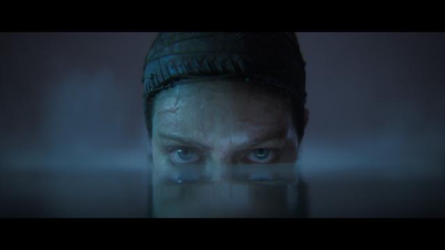 Senua's eyes watching you over the dead still surface of the water, her face submerged by half in it.