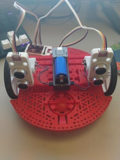 A Pololu Romi Robot Chassis with an M5Stack Atom lite, the Atom Motion, two I2C M5 Ultra Sonic units, and a I2C hub.