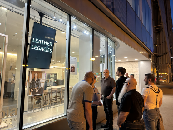 The group gathers in front of the Leather Legacy display on Michigan Avenue