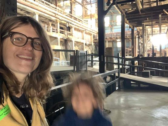 Woman and blurry jumping kid inside the Britannia mine building.