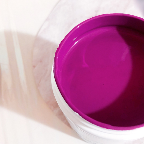 Open paint can with magenta paint