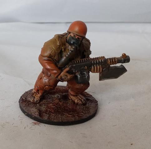 One ogyrn holding his gun and looking to one side.