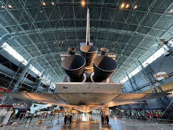 Photo of the Space Shuttle main engines taken from slightly below.