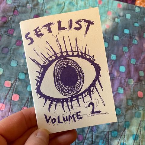 An A7 riso-printed zine, this time with purple ink on grainy-looking cream recycled paper. On the cover it says 'SETLIST Volume 2'.