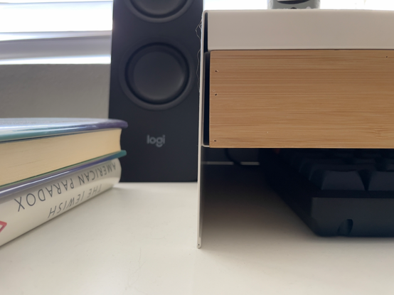 Close up of an IKEA Elloven monitor stand showing the thin metal bending outward under the weight of my MSI monitor