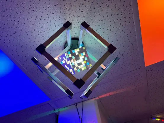 A very cool looking light, with a rgb cube inside of a cube frame. RGB ceiling lights on either side
