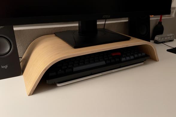 IKEA SIGFINN monitor stand supporting an 17.75 lb, 27” MSI monitor while producing space for storing my keyboard. I also slid my laptop under the keyboard for fun.