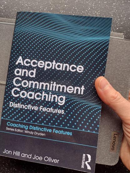 A book titled "Acceptance and commitment coaching - Distinctive features" written by Jon Hill and Joe Oliver