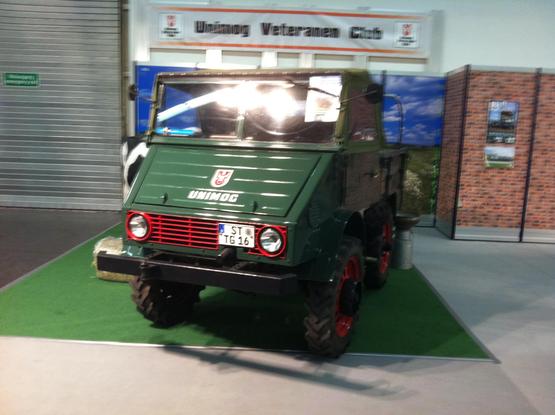 Early Unimog with gloss green bodywork and bright red grille, frontal view