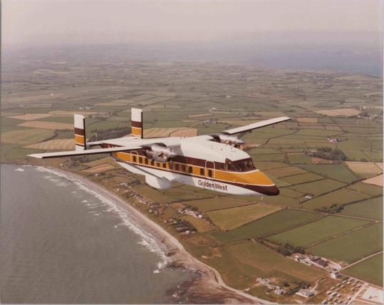 Likely a delivery flight photo. The coast looks more like the english country side than California. The plane is flying at the viewer.
