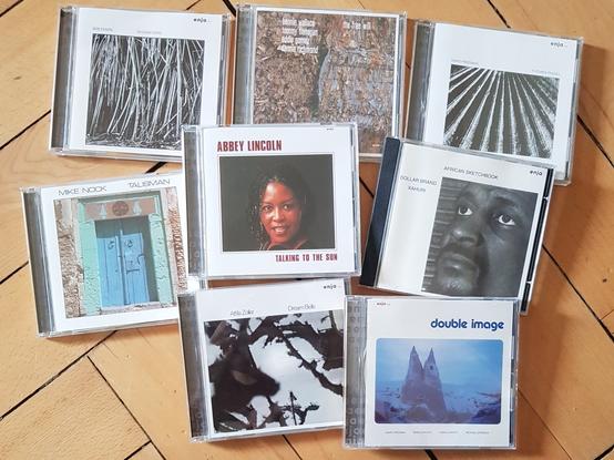 assembly of CDs on wooden floor: from top left to bottom right: Bob Degen, "Sequoia Song"; Bennie Wallace, "The Free Will"; David Friedman, "Futures Passed"; Mike Nock, "Talisman"; Abbey Lincoln, "Talking to the Sun"; Dollar Brand Xahuri (Abdullah Ibrahim), "African Sketchbook"; Attila Zoller, "Dream Bells"; David Friedman/David Samuels, "Double Image"
