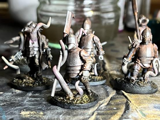 A bunch of figures in rusty armour, slogging through mud and tangled in choking roots