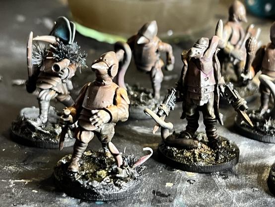 A bunch of figures in rusty armour, slogging through mud and tangled in choking roots