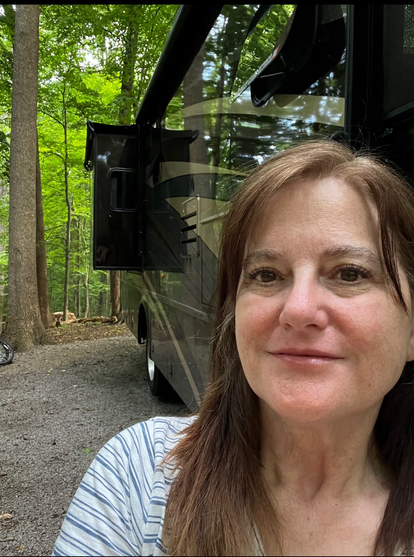 Mad Hildebrandt by her RV in a campsite